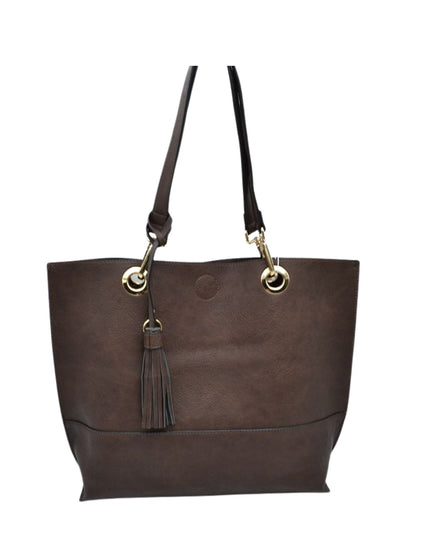 Brown leather tote bag with a tassel on a white background