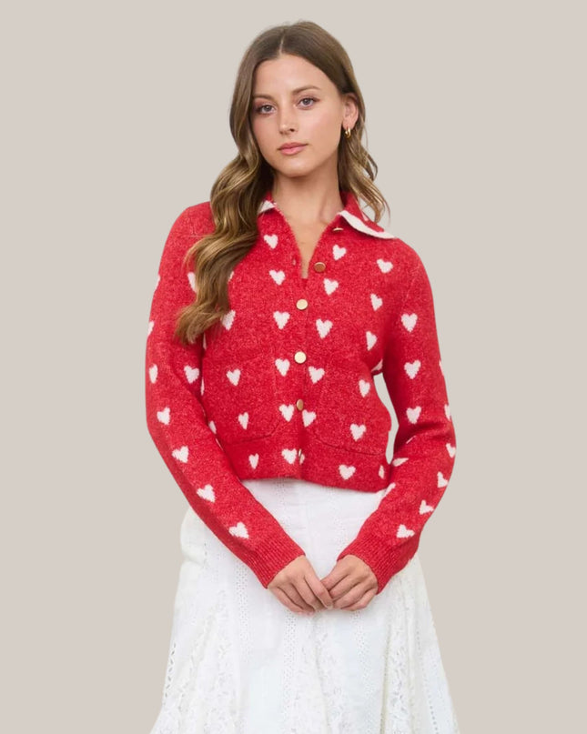 Woman wearing a red sweater with heart patterns on a beige background