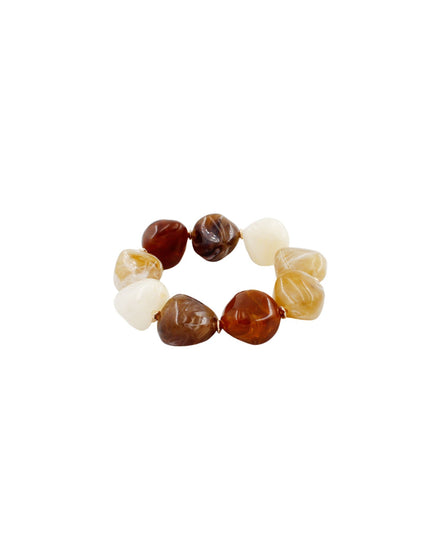A beaded stretch bracelet featuring a mix of polished stone beads in dark brown, cream, and light amber, arranged in a circular shape against a plain white background.