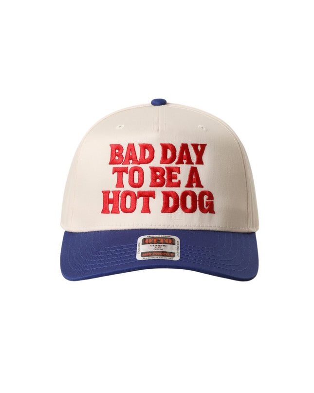 Beige and blue cap with red text 'Bad Day to be a Hot Dog' on a white background