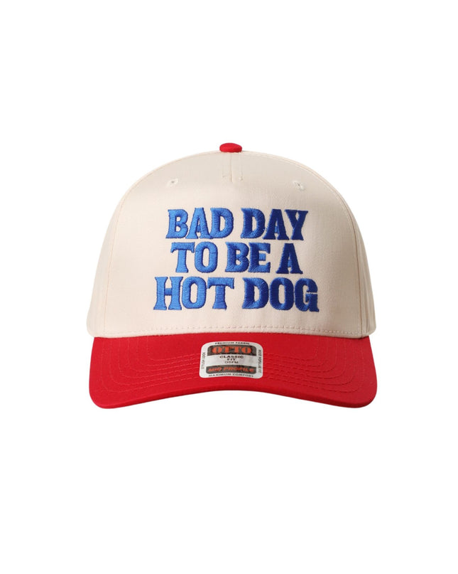 Cap with 'Bad Day to be a Hot Dog' text on a white background