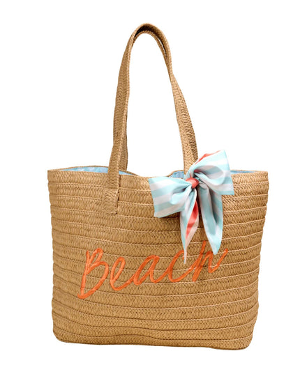 Woven beach bag with 'Beach' embroidery and a bow on a white background