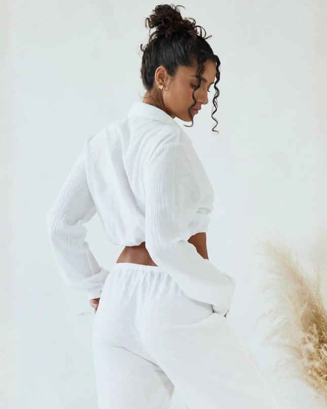 Woman wearing a white outfit with a blurred background