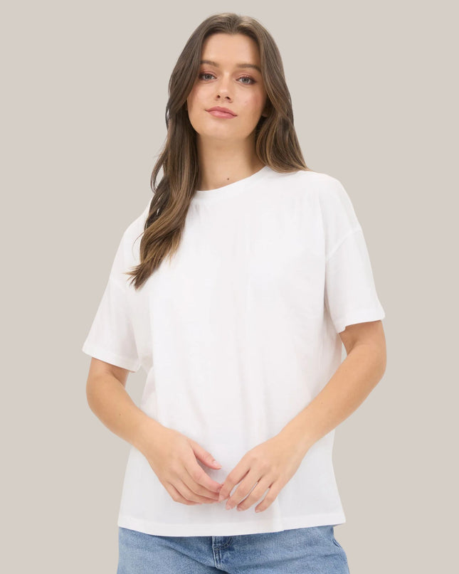Woman wearing a plain white t-shirt against a neutral background