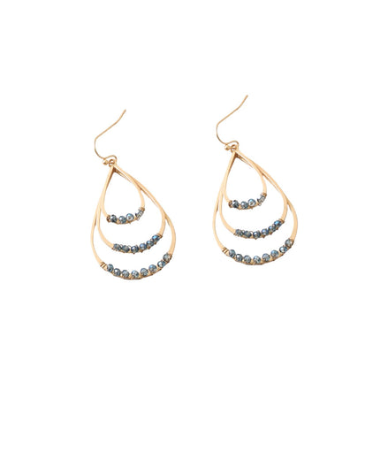 A pair of gold teardrop-shaped dangle earrings with three curved rows of small round blue-gray crystals, shown on a plain white background.
