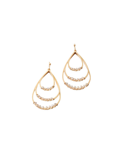 A pair of gold teardrop-shaped dangle earrings with three curved tiers, each accented with a row of small clear stones, shown on a plain white background.