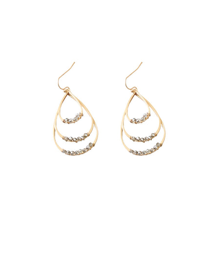 A pair of gold teardrop-shaped dangle earrings with three nested curved bands, each studded with small clear rhinestones, shown against a plain white background.