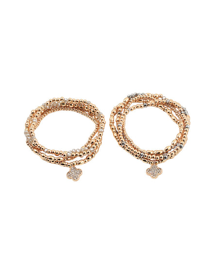 A pair of rose gold multi-strand beaded bracelets with small heart-shaped charms, displayed on a clean white background.