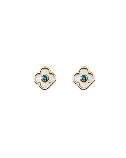 A pair of gold four-petal flower stud earrings with white inlay and a small round blue-green stone in the center, shown on a plain white background.