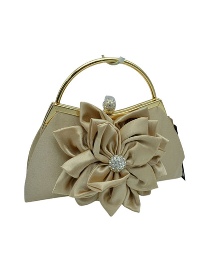 A champagne beige satin evening handbag with a large fabric flower applique on the front, a gold-tone metal top handle, and a rhinestone-embellished clasp.