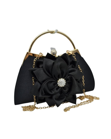 Black satin evening handbag with a large fabric flower embellishment, gold-tone metal frame, top handle, and chain strap on a white background.