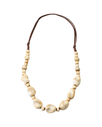 A beaded necklace featuring large, irregular cream-colored shell beads in the center, flanked by smaller round beads, with a dark brown adjustable cord at the top, shown on a plain white background.