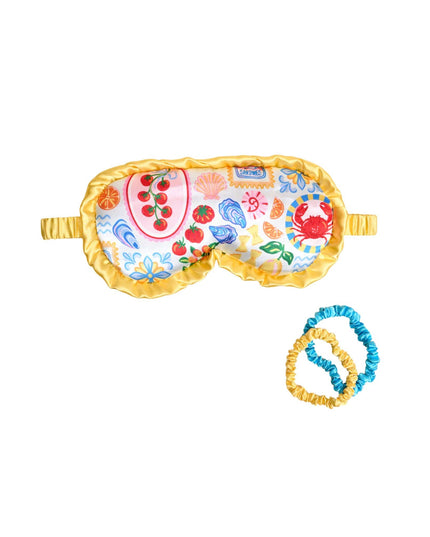 Decorative eye mask with colorful patterns and a matching blue and yellow rubber band on a white background