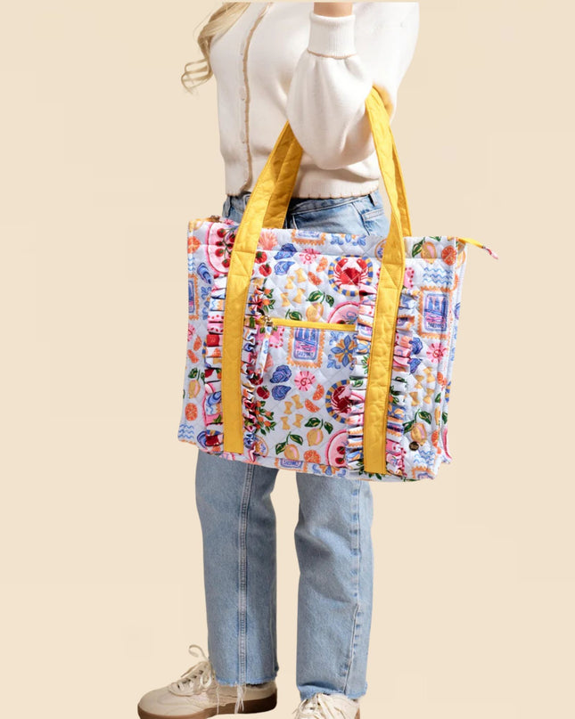 Person holding a colorful tote bag with yellow straps on a beige background