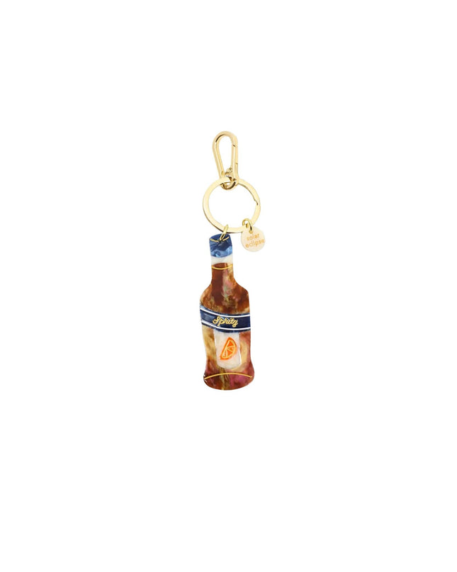 A miniature bottle charm with a gold-tone clasp and a small pearl bead, featuring a detailed label design.