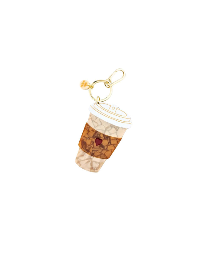 A coffee cup charm with a gold-tone clasp, featuring a beige and brown marbled pattern with a small red heart detail, on a solid white background.
