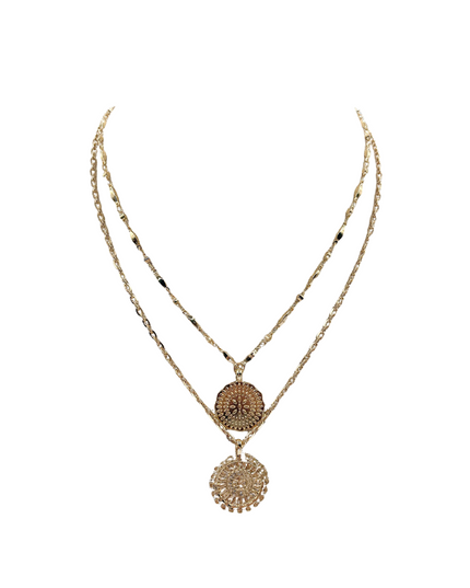A double-strand gold-toned necklace featuring a short chain with a round textured pendant and a longer chain with a larger circular filigree pendant, displayed on a solid white background.