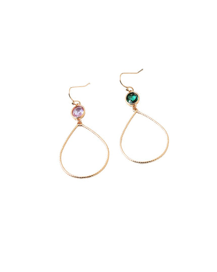 A pair of gold-tone teardrop dangle earrings with textured wire loops, featuring one earring with a round light purple stone and the other with a round green stone, shown on a plain white background.