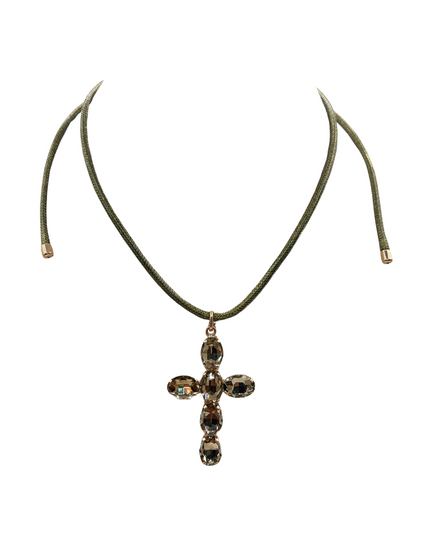 A cross pendant necklace featuring a dark green cord and a cross-shaped setting with faceted brown and gold-toned crystals, shown against a plain white background.