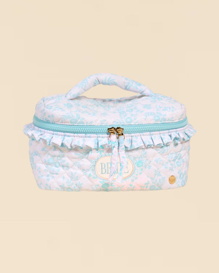 Small, round, pastel-colored bag with a visible brand logo on a beige background