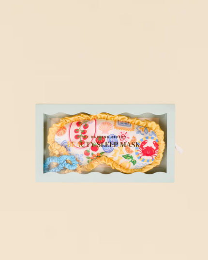 Floral eye mask in a box on a beige background