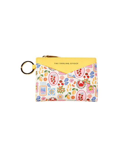 Small pouch with colorful pattern and yellow top on a white background