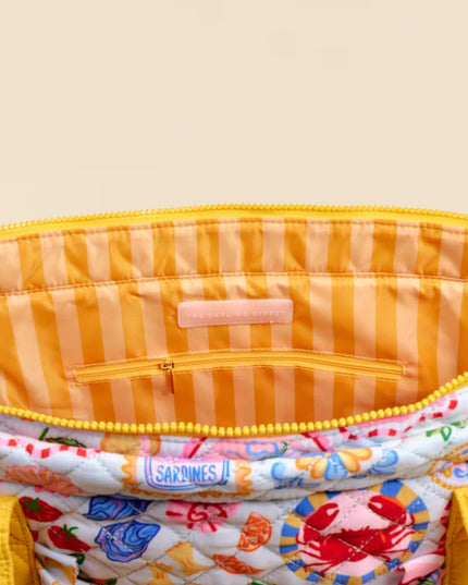 Colorful striped bag with a floral pattern inside on a beige background