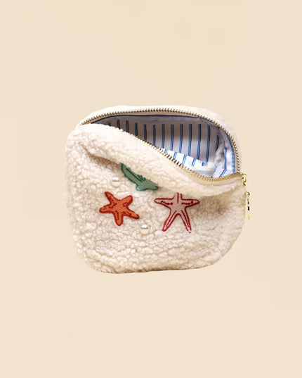 Small pouch with starfish designs on a beige background