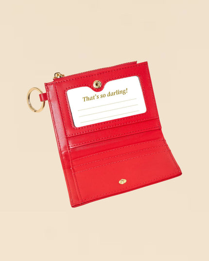 Red wallet with a card holder on a beige background