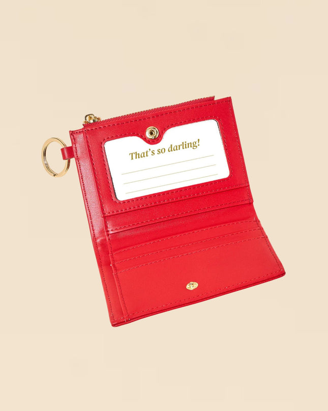 Red wallet with a card holder on a beige background
