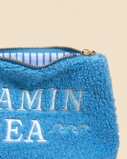 Blue fleece pouch with 'Vitamin Sea' text on a beige background