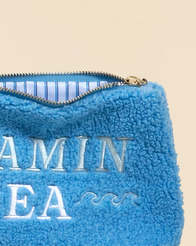 Blue fleece pouch with 'Vitamin Sea' text on a beige background