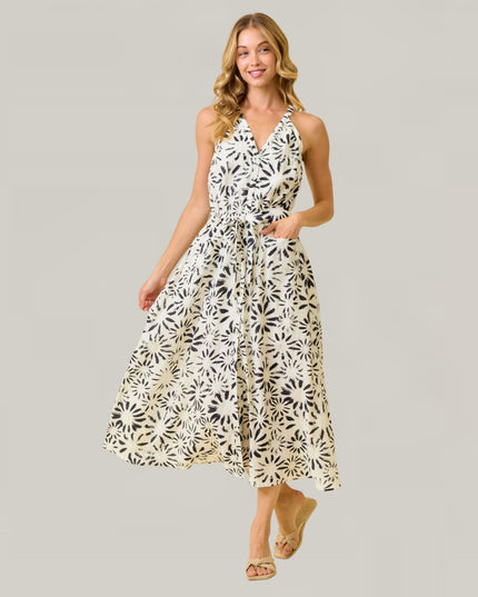 Woman wearing a floral dress on a gray background