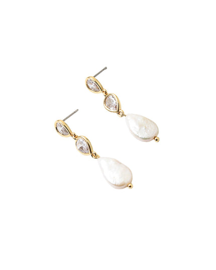 A pair of gold drop earrings featuring a small teardrop-shaped clear stone above a larger irregular white pearl drop, shown on a plain white background.