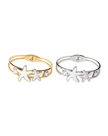 Two double-band cuff bracelets with starfish charms, one in gold and one in silver, displayed side-by-side on a plain white background.