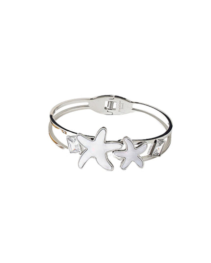 A silver-toned double-band cuff bracelet featuring two starfish charms and small clear rhinestone accents, shown on a plain white background.