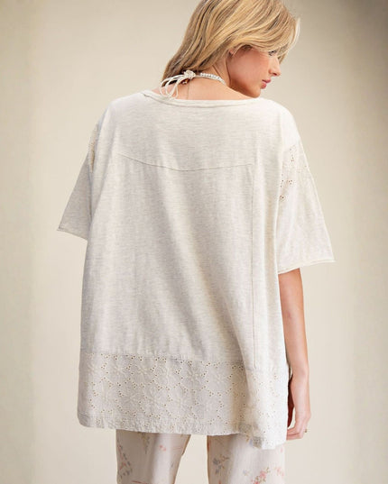 Woman wearing a light-colored kimono-style garment against a plain background