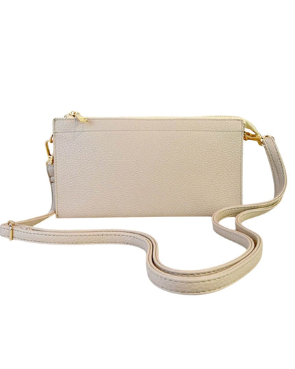 A small rectangular pebbled leather crossbody bag in a light cream color with gold-tone hardware and a matching adjustable shoulder strap, shown on a plain white background.