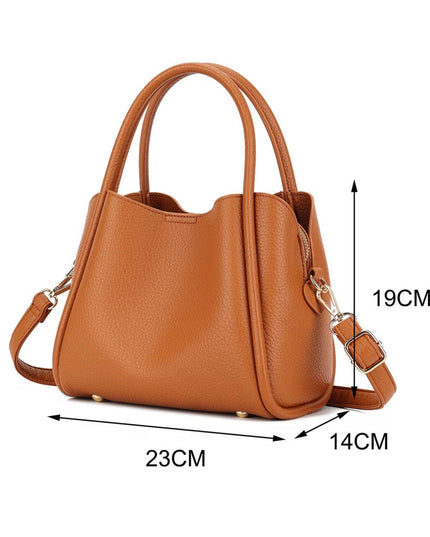 A tan pebbled leather handbag with dual top handles and a detachable shoulder strap, shown on a white background with dimension lines indicating 23CM width, 14CM depth, and 19CM height.