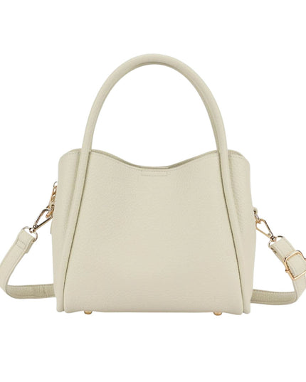 A light cream-colored pebbled leather handbag with dual top handles, a detachable shoulder strap, and gold-tone hardware, shown against a plain white background.