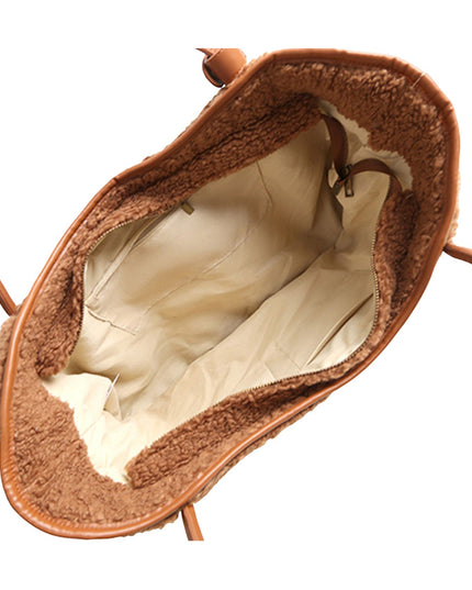 The interior of a brown leather handbag lined with plush brown shearling fleece and a cream-colored fabric lining, shown against a plain white background.