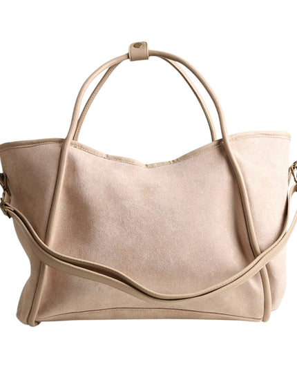 A light beige suede or faux-suede tote bag with dual top handles and a detachable shoulder strap, shown against a plain white background.