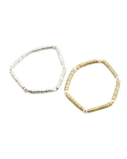 Two beaded hexagonal stretch bracelets on a plain white background. One bracelet is white with black textured details and white beads, and the other is gold with black textured details and white beads.