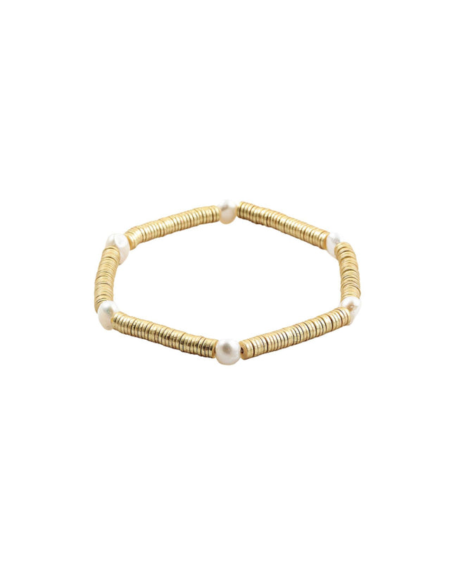 A gold beaded stretch bracelet with small white pearl accents, displayed on a clean white background.