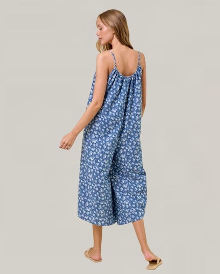 Woman wearing a blue floral dress on a plain background