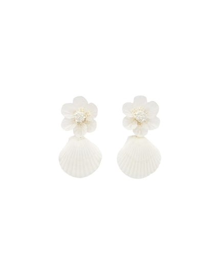 A pair of white shell and flower drop earrings on a solid white background.