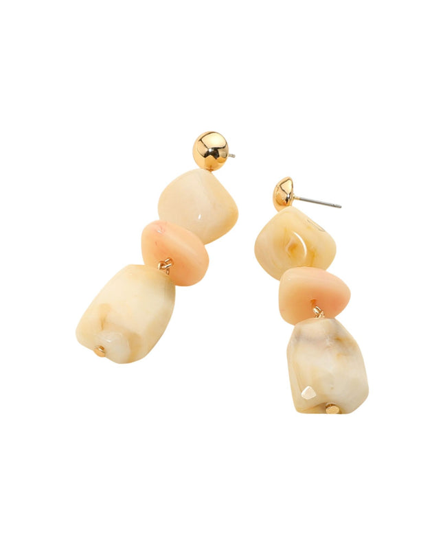 Pair of earrings with beige and orange beads on a white background
