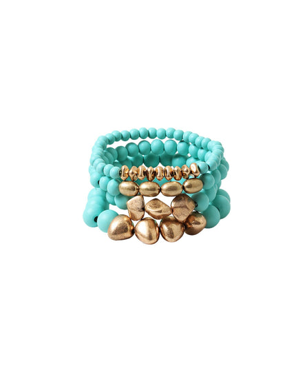 A stack of turquoise beaded bracelets with a central gold-toned metallic shell and bead accent, shown on a plain white background.