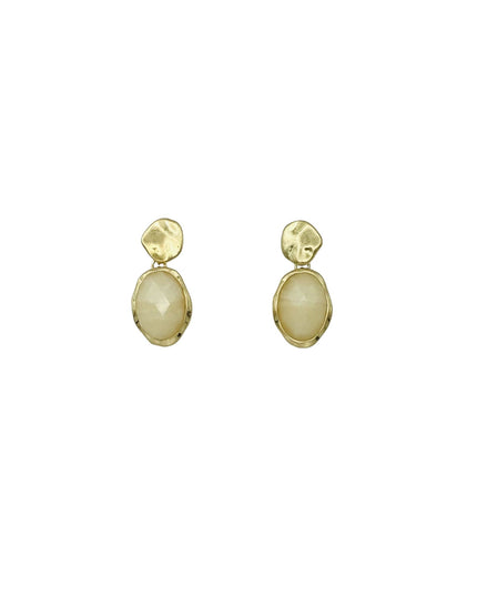 A pair of gold drop earrings featuring a small textured gold top and a larger oval cream-colored stone below, set against a plain white background.
