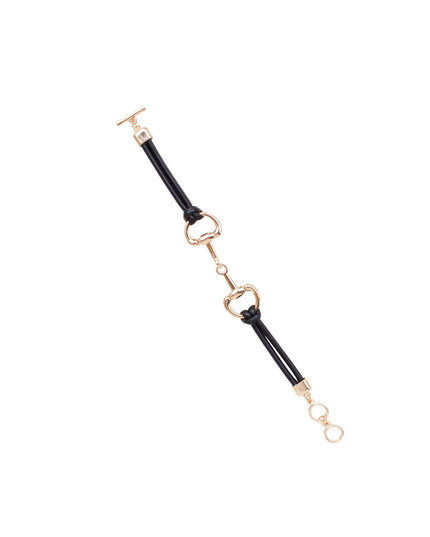 A black leather strap bracelet with gold-tone metal hardware, including horsebit-style rings and a toggle clasp, shown on a plain white background.